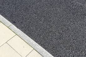 Dark gray carpet meeting light tile flooring