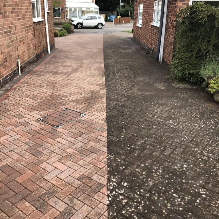 Driveway split in half showing before and after power washing, with clean brick pavers on left and algae-covered surface on right