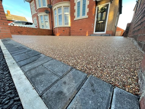 Stone paving leading to gravel courtyard
