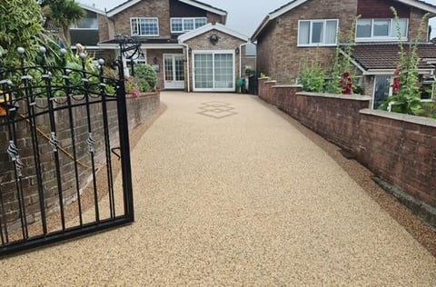 Gravel driveway with black metal gate