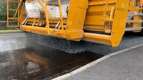 Asphalt paving machine laying hot asphalt
