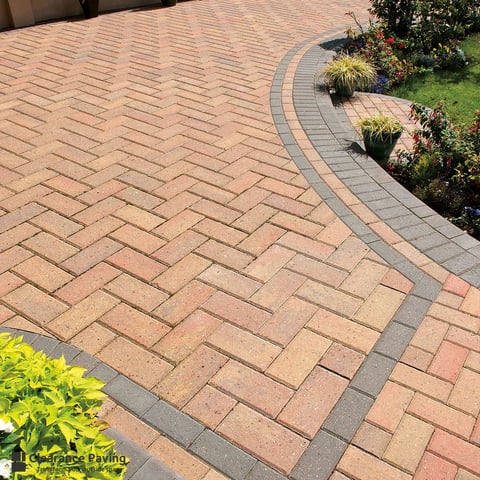 Decorative paved driveway with terracotta and gray herringbone pattern